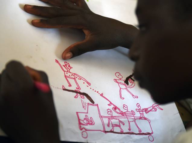 Jovens refugiados desenham cenas de ataque durante programa de terapia da UNICEF, próximo a Baga Sola Jovens refugiados desenham cenas de ataque durante programa de terapia da UNICEF, próximo a Baga Sola