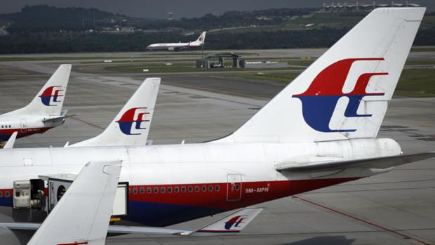 Boeing 777-200 da Malaysia Airlines na pista em foto tirada através de um vidro no aeroporto internacional de Kuala Lumpur