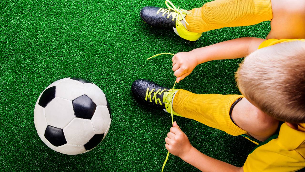 Menino jogando futebol