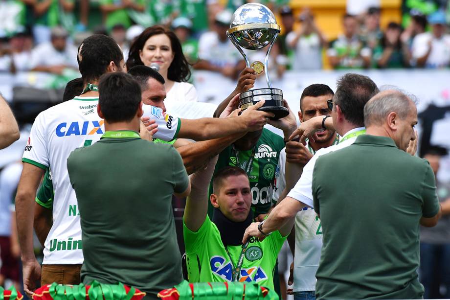 Jackson Follmann, um dos sobreviventes na tragédia em Medellin, levanta a taça da Copa Sul-Americana antes do amistoso entre Chapecoense e Palmeiras, na Arena Condá em Chapecó