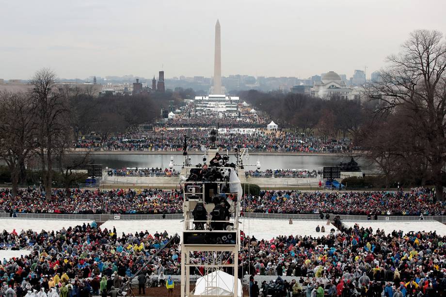 Pessoas começam a chegar para a cerimônia de posse de Donald Trump diante do Monumento de Washington enquanto parte da cidade é iluminada pelo sol no amanhecer