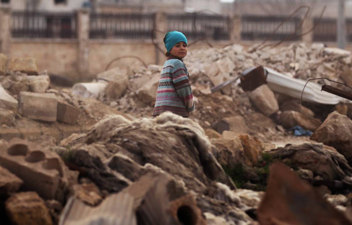 A child walks through rubble of damaged buildings in al-Rai town, northern Aleppo countryside, Syria January 20, 2017. REUTERS/Khalil Ashawi