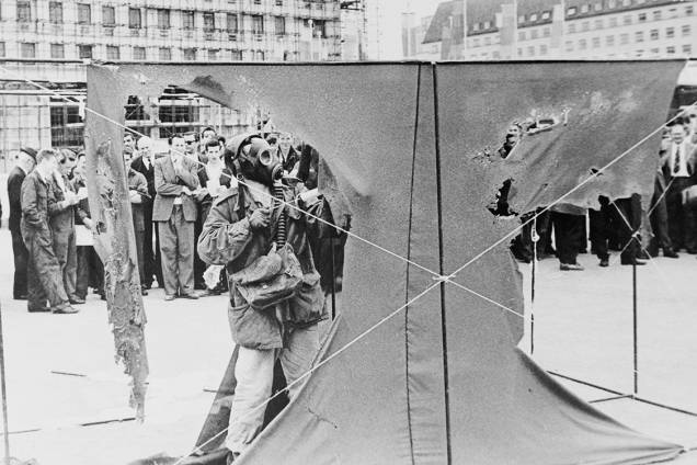 O artista alemão Gustav Metzger veste uma máscara de gás enquanto pinta cortinas de nylon com ácido clorídrico, fazendo com que se desintegram, em 1961 O artista alemão Gustav Metzger veste uma máscara de gás enquanto pinta cortinas de nylon com ácido clorídrico, fazendo com que se desintegram, em 1961