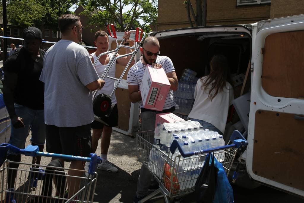 Mantimentos s&atilde;o descarregados de uma van para auxiliar os afetados pelo inc&ecirc;ndio no edif&iacute;cio Grenfell Tower, em Londres - 14/06/2017
