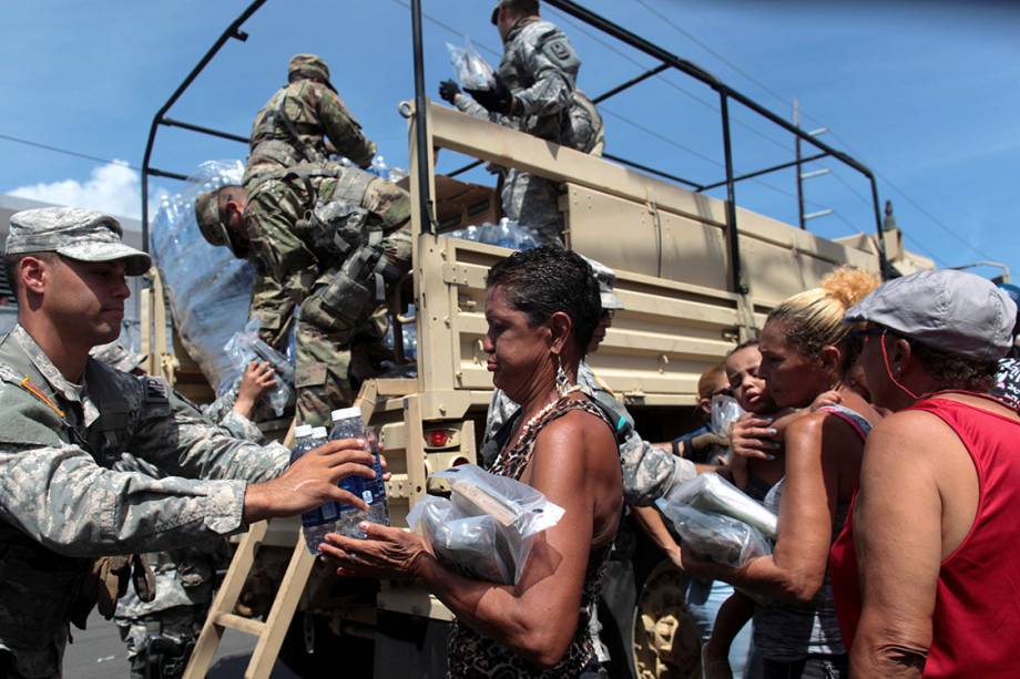 Soldados distribuem água e outros mantimentos para moradores atingidos pelo furacão Maria, em San Juan, Porto Rico