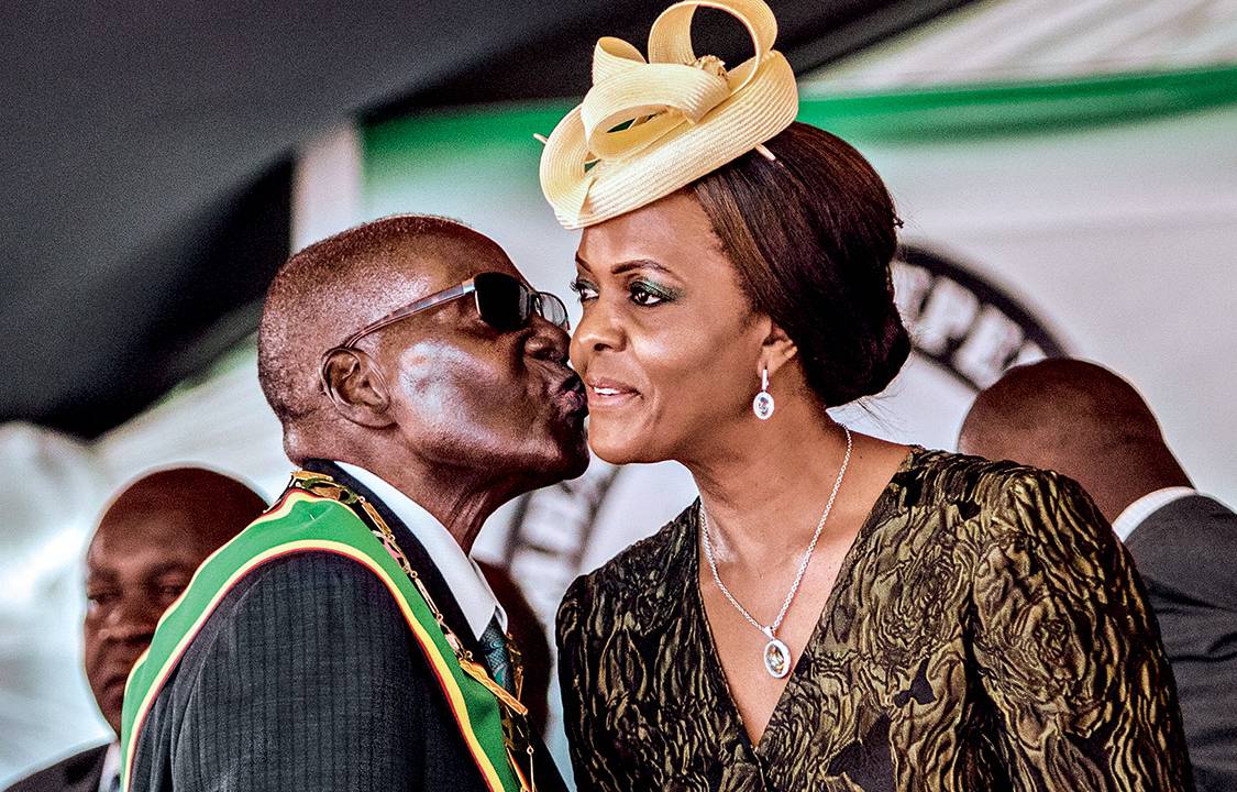 (FILES) This file photo taken on April 18, 2017 shows President Robert Mugabe kissing his wife and first lady Grace Mugabe during during the country's 37th Independence Day celebrations at the National Sports Stadium in Harare. Zimbabwe's military appeared to be in control of the country on November 15, 2017 as generals denied staging a coup but used state television to vow to target "criminals" close to President Robert Mugabe. Mnangagwa's dismissal left Mugabe's wife Grace, 52, in prime position to succeed her husband as the next president -- a succession strongly opposed by senior ranks in the military. / AFP PHOTO / Jekesai NJIKIZANA