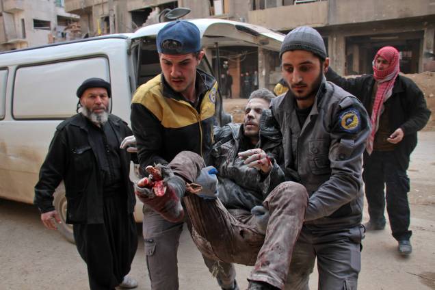 Homem é socorrido por membros da defesa civil da Síria. Os ataques aéreos do regime após três dias de intensos bombardeios no reduto rebelde de Ghouta já deixaram ao menos 300 mortos - 20/02/2018 Homem é socorrido por membros da defesa civil da Síria. Os ataques aéreos do regime após três dias de intensos bombardeios no reduto rebelde de Ghouta já deixaram ao menos 300 mortos - 20/02/2018