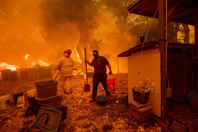 Lane Lawder, morador de área próxima a cidade de Clearlake Oaks tenta salvar sua casa de incêndio na Califórnia - 04/08/2018 Lane Lawder, morador de área próxima a cidade de Clearlake Oaks tenta salvar sua casa de incêndio na Califórnia - 04/08/2018