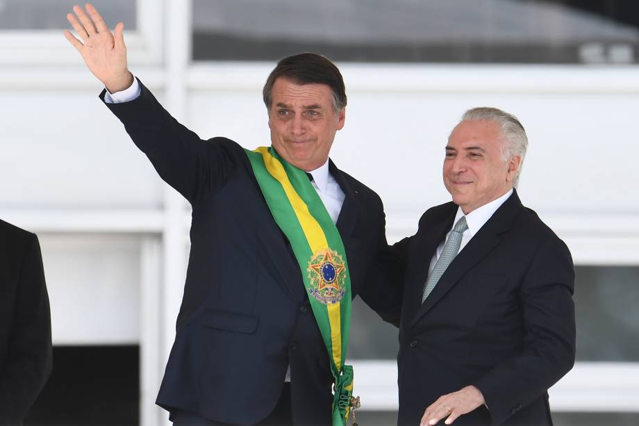 Presidente Jair Bolsonaro recebe a faixa presidencial do ex-presidente Michel Temer após subir a rampa do Palácio do Planalto, em Brasília - 01/01/2019 Presidente Jair Bolsonaro recebe a faixa presidencial do ex-presidente Michel Temer após subir a rampa do Palácio do Planalto, em Brasília - 01/01/2019