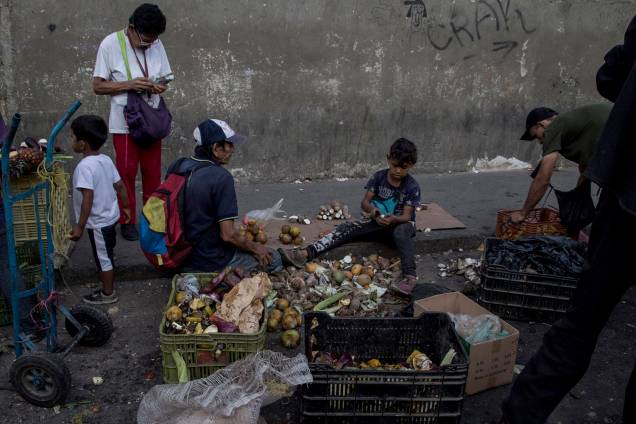 Venezuelanos coletam restos de frutas e vegetais de mercado de rua em Caracas, Venezuela - 18/05/2018 Venezuelanos coletam restos de frutas e vegetais de mercado de rua em Caracas, Venezuela - 18/05/2018