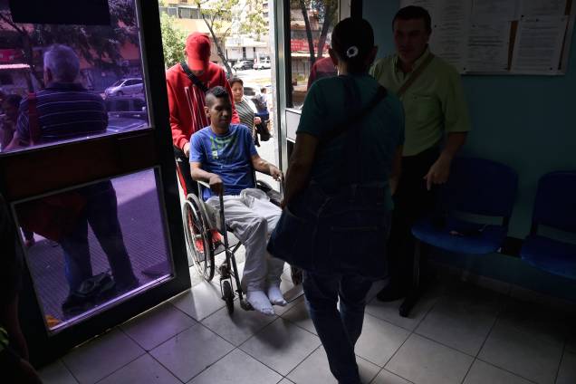 Parentes empurram um homem em uma cadeira de rodas em um clínica de tratamento para insuficiência renal estatal em Caracas, na Venezuela no terceiro do apagão que afeta praticamente toda a Venezuela - 10/03/2019 Parentes empurram um homem em uma cadeira de rodas em um clínica de tratamento para insuficiência renal estatal em Caracas, na Venezuela no terceiro do apagão que afeta praticamente toda a Venezuela - 10/03/2019