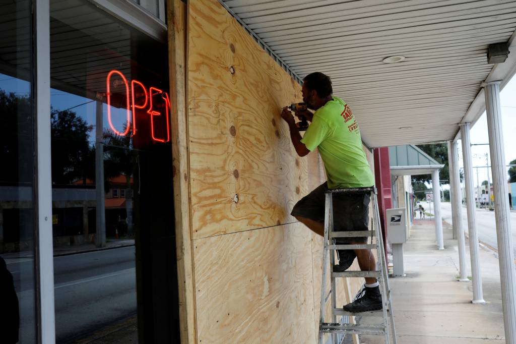 FILE PHOTO: A man boards up a business ahead of the arrival of Hurricane Dorian in Cocoa FILE PHOTO: A man boards up a business ahead of the arrival of Hurricane Dorian in Cocoa