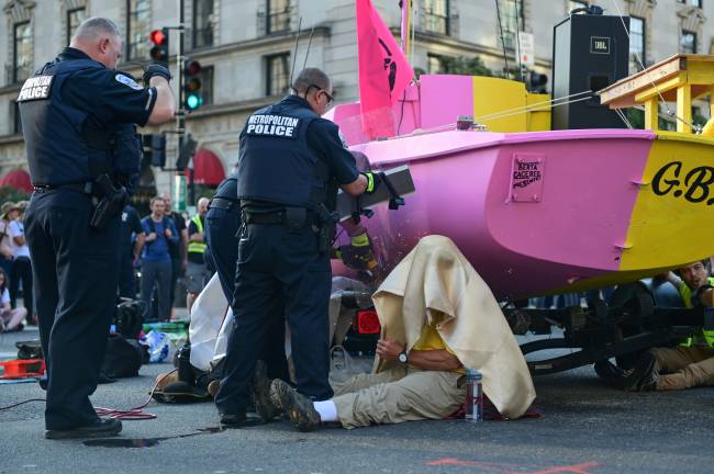 Police work to remove protesters from a boat being used to block traffic at an intersection near the White House in Washington Police work to remove protesters from a boat being used to block traffic at an intersection near the White House in Washington