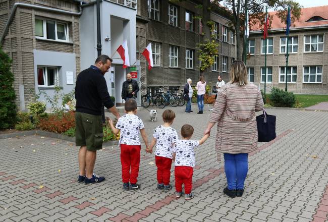 People are seen outside a polling station during parliamentary election, in Warsaw