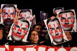 People hold placards depicting Spain’s acting Prime Minister Pedro Sanchez during a protest against his presence in Viladecans, near Barcelona People hold placards depicting Spain’s acting Prime Minister Pedro Sanchez during a protest against his presence in Viladecans, near Barcelona