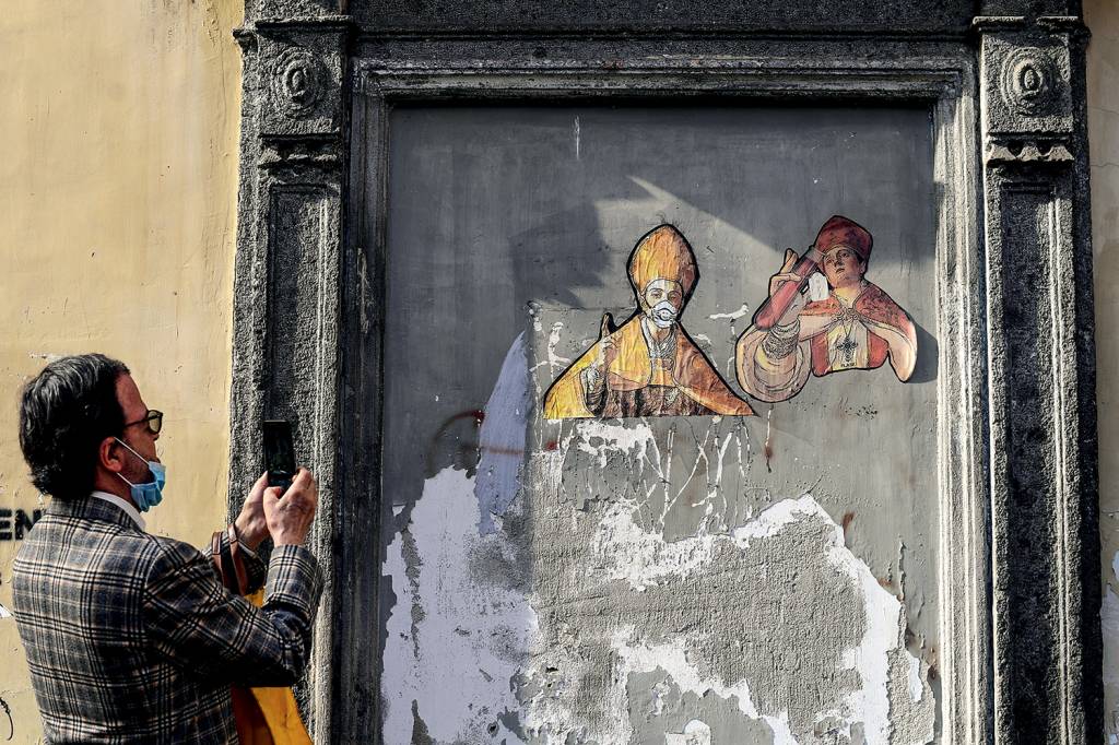 A man take a picture of a mural painting depicting two A man take a picture of a mural painting depicting two