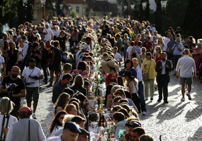 Residents dine at the medieval Charles Bridge in Prague