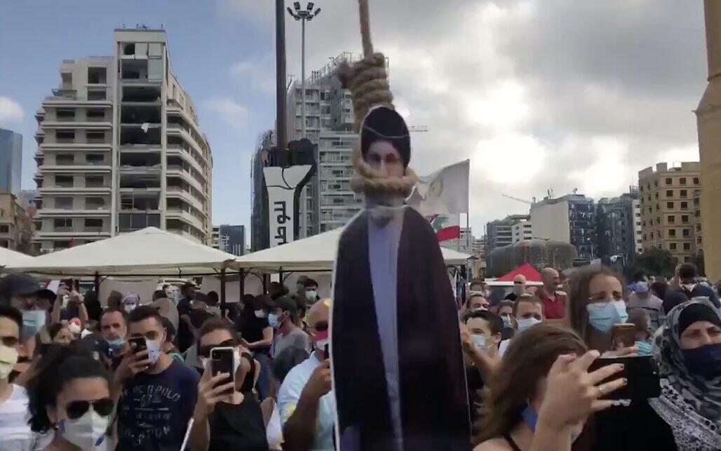 Um cartaz do líder do Hezbollah, Hassan Nasrallah, enforcado, durante os protestos em Beirute