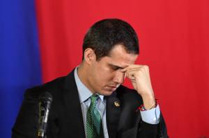 (FILES) In this file photo taken on February 18, 2020 Venezuelan opposition leader and self-proclaimed acting president Juan Guaido gestures during a plenary session of the National Assembly at the San Antonio municipal theatre in San Antonio de Los Altos south of Caracas. - A new Venezuelan parliament will be sworn in on January 5, 2021 with the party of President Nicolas Maduro now in almost complete control and the main thorn in his side, Western-backed opposition leader Juan Guaido, out in the political cold. (Photo by Federico PARRA / AFP)