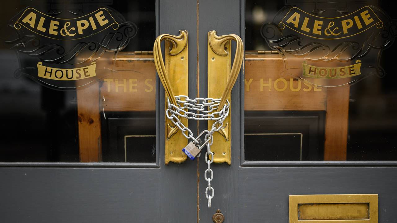 Um cadeado e uma corrente protegem a porta de um pub temporariamente fechado em Londres, na Inglaterra -