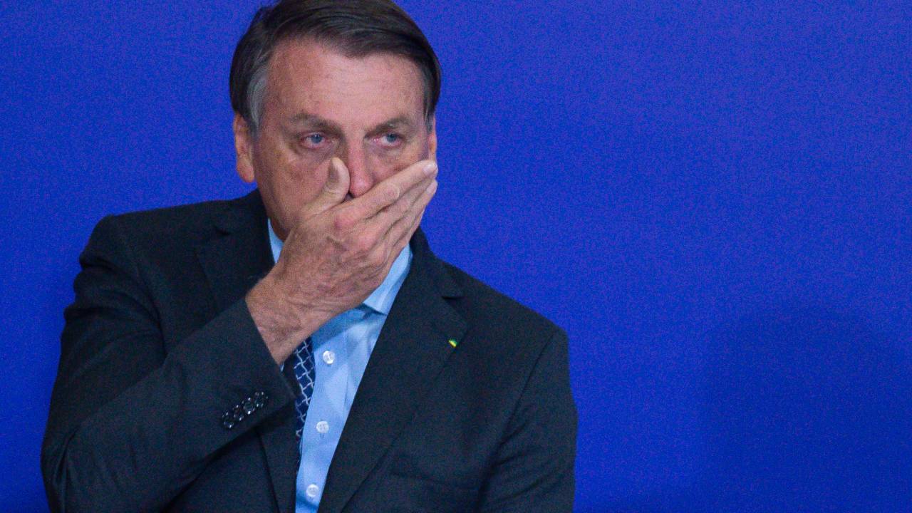 BRASILIA, BRAZIL - NOVEMBER 09: President of Brazil Jair Bolsonaro touches his face during Volunteering Alliance launch amidst the coronavirus (COVID-19) pandemic at the Planalto Palace on November 09, 2020 in Brasilia. Brazil has over 5.064,000 confirmed positive cases of Coronavirus and has over 162,397 deaths. (Photo by Andressa Anholete/Getty Images)