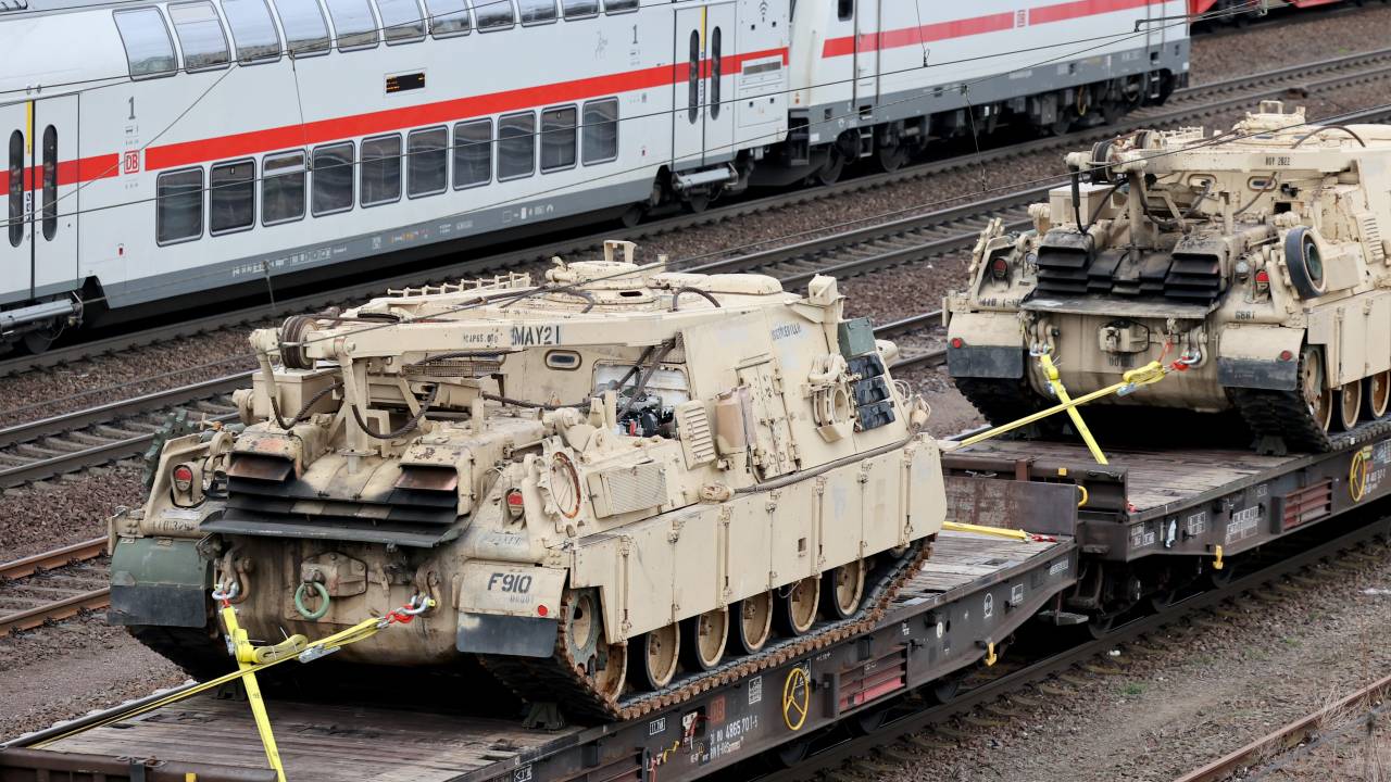05 April 2022, Saxony-Anhalt, Magdeburg: A train carrying U.S. Army military vehicles, including M88 armored recovery vehicles, passes through Magdeburg-Sudenburg station in the evening, heading east. Photo: Peter Gercke/dpa (Photo by Peter Gercke/picture alliance via Getty Images)