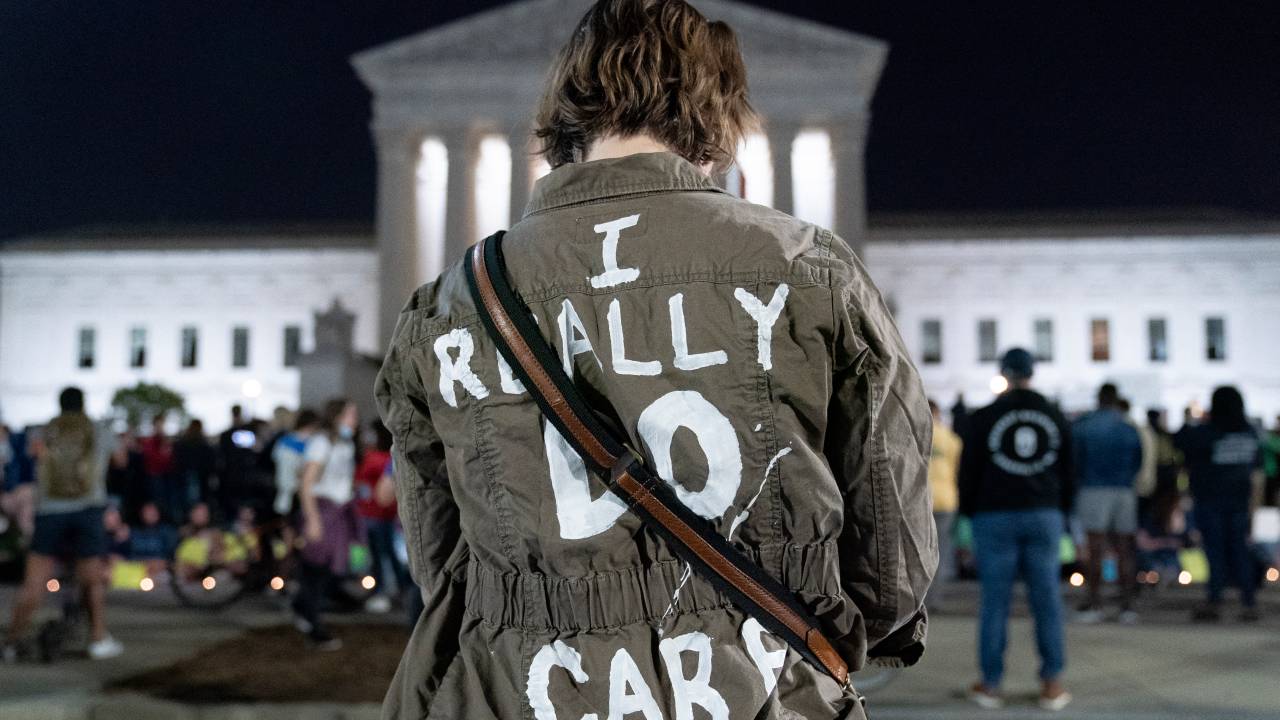 A woman wears a jacket reading I really do care at the US Supreme Court in Washington, DC, on May 2, 2022. - The Supreme Court is poised to strike down the right to abortion in the US, according to a leaked draft of a majority opinion that would shred nearly 50 years of constitutional protections. The draft, obtained by Politico, was written by Justice Samuel Alito, and has been circulated inside the conservative-dominated court, the news outlet reported. Politico stressed that the document it obtained is a draft and opinions could change. The court is expected to issue a decision by June. The draft opinion calls the landmark 1973 Roe v Wade decision "egregiously wrong from the start." (Photo by Stefani Reynolds / AFP)