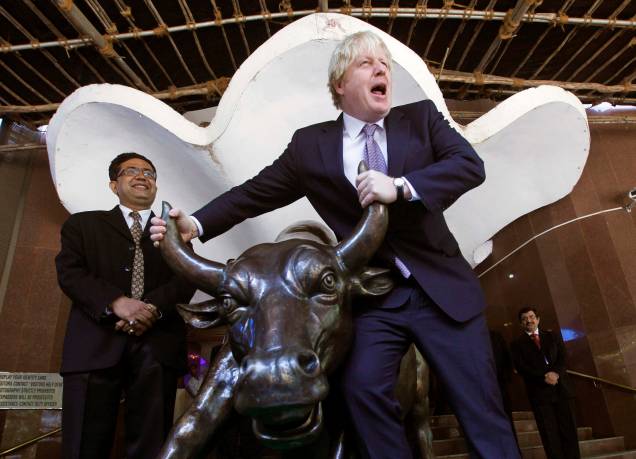 O então prefeito de Londres Boris Johnson posa com a estátua de bronze de um touro ao lado da Bolsa de Valores de Bombaim, Índia, em 30/11/2012. O então prefeito de Londres Boris Johnson posa com a estátua de bronze de um touro ao lado da Bolsa de Valores de Bombaim, Índia, em 30/11/2012.
