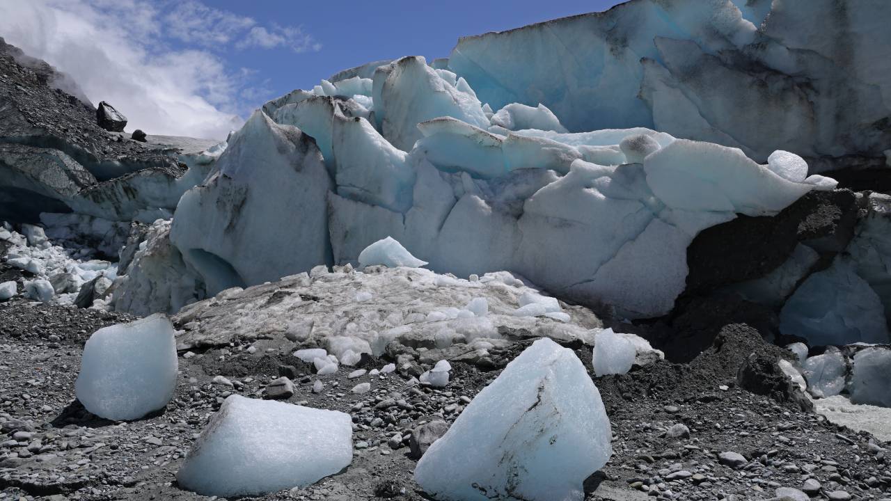 ZERMATT, SWITZERLAND - JUNE 22: Ice breaks off the receding Findel glacier on June 22, 2022 near Zermatt, Switzerland. The Findel glacier, which descends from the Monta Rosa massif, once filled a wide ravine running over two kilometers below its current terminus. Matthias Huss, a glaciologist with ETH Zurich university and head of the Swiss glacier monitoring network, has been studying the Findel and reports that the glacier is losing mass at a rate significantly faster than average since 2011. This summer is likely to be especially brutal for Switzerland’s glaciers. Normally in mid-June glaciers, including the Findel, would still be covered in snow that protects them from the sun, though because very little snow fell this year, the glaciers are already exposed and melting rapidly under conditions that are more typical for late July or August. Huss and his colleagues are studying approximately 20 glaciers across Switzerland to observe the effects of global warming. All of the glaciers are melting, and he predicts that if we do not meet global climate goals Switzerland’s glaciers will be mostly gone by 2100. (Photo by Sean Gallup/Getty Images)