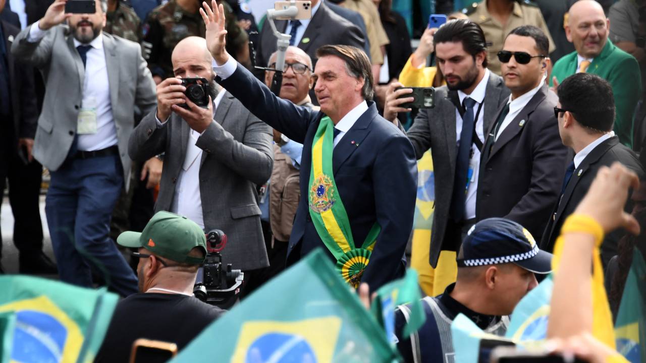 Brazilian President Jair Bolsonaro waves at the crowd during a military parade to mark Brazil's 200th anniversary of independence in Brasilia, on September 7, 2022. (Photo by EVARISTO SA / AFP)