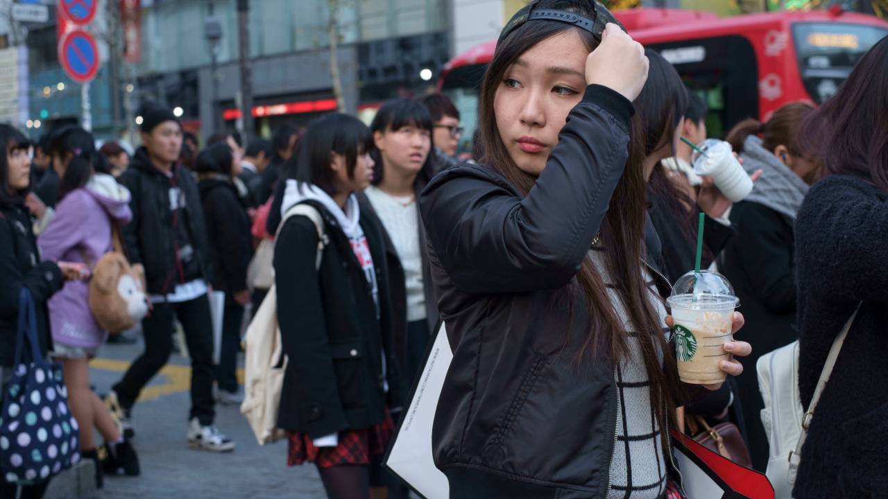 Crowds at the Sibuya crossing in front of Shibuya station. The crossing is reputed to be one of the world's busiest. Known as the Scramble people come from all directions at once when the lights change. Tokyo, japan. (Photo by In Pictures Ltd./Corbis via Getty Images)
