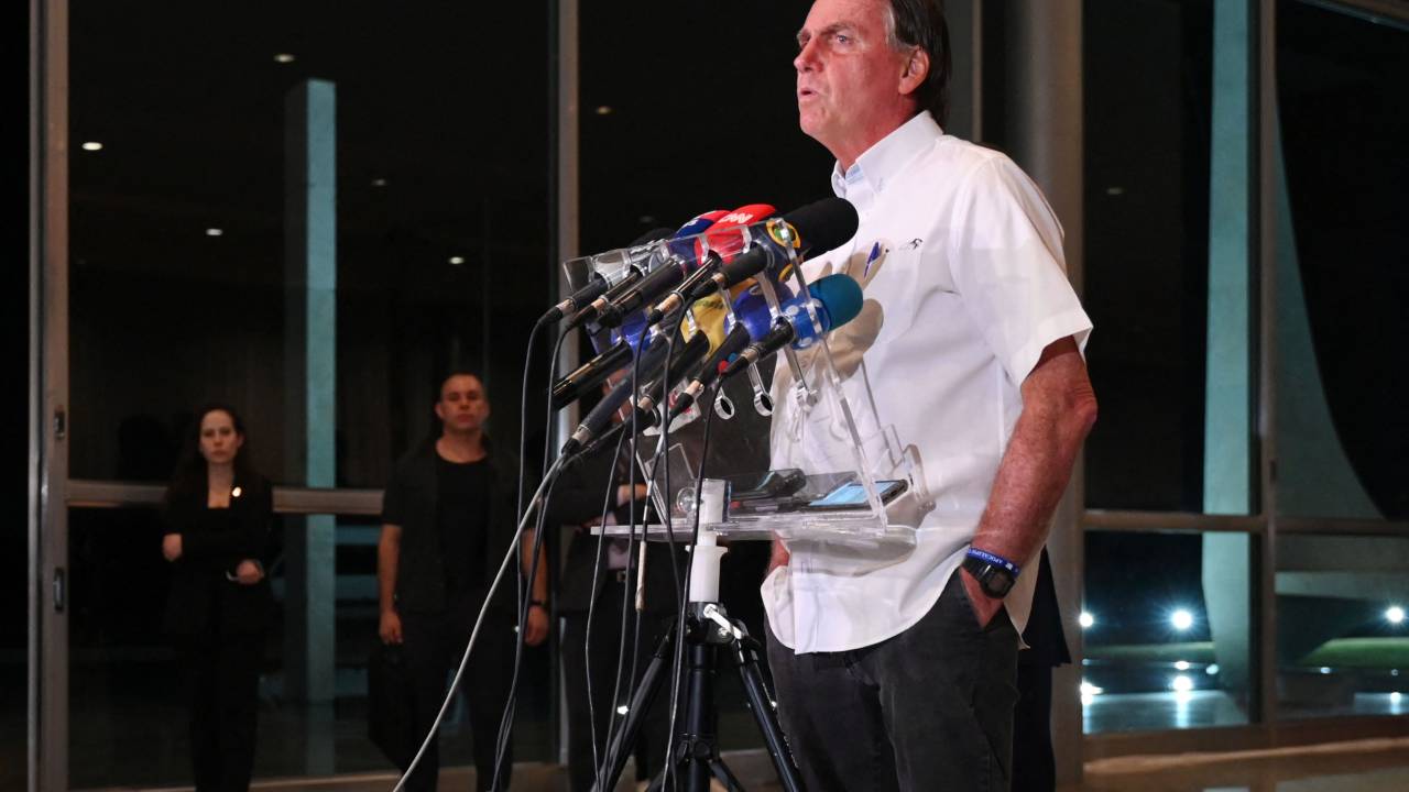 Brazilian President and re-election candidate Jair Bolsonaro gestures during a press conference at the Alvorada Palace in Brasilia, on October 26, 2022. - The Brazilian Superior Electoral Court (TSE) denied on Wednesday a request from the campaign for the re-election of Jair Bolsonaro to investigate alleged irregularities in the transmission of radio electoral propaganda, a fact described as serious by the president. (Photo by EVARISTO SA / AFP)