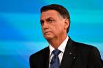 Brazilian President and reelection candidate for the Liberal Party (PL) Jair Bolsonaro gestures before the start of the television debate at the Globo TV studio in Rio de Janeiro, Brazil, on October 28, 2022. - After a bitterly divisive campaign and inconclusive first-round vote, Brazil will elect its next president on October 30, in a cliffhanger runoff between far-right incumbent Jair Bolsonaro and veteran leftist Luiz Inacio Lula da Silva. (Photo by MAURO PIMENTEL / AFP)