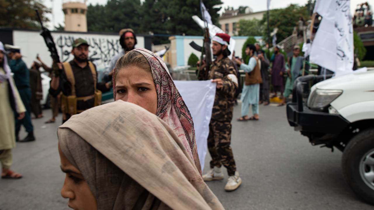 KABUL, AFGHANISTAN - AUGUST 15: Women walk down the street during a celebration of the first anniversary of the Taliban's return to power on August 15, 2022 in Kabul, Afghanistan. A year after the Taliban retook Kabul, cementing their rule of Afghanistan after a two-decade insurgency, the country is beset by economic and humanitarian crises. Western governments have frozen billions of dollars in Afghan assets as it presses the Taliban to honor unmet promises on security, governance and human rights, including allowing all girls to be educated. (Photo by Nava Jamshidi/Getty Images)