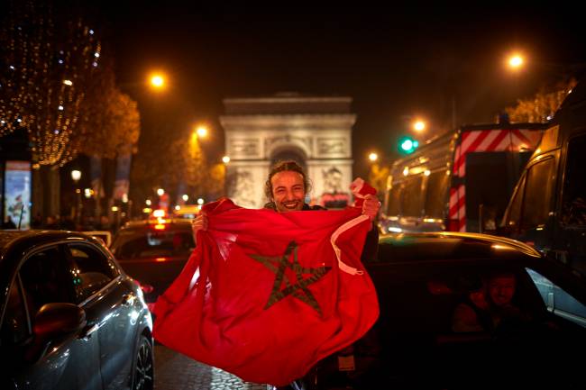 Morocco Fans celebrate Around the World PARIS, FRANCE - DECEMBER 10: Morocco Fans celebrate on the Champs Elysees after their team's 1-0 victory over Portugal to reach the semi-finals of the Fifa World Cup on December 10, 2022 in Paris, France. Morocco's victory marks the first time an African nation has qualified for the semi-finals of a FIFA World Cup. (Photo by Kiran Ridley/Getty Images)
