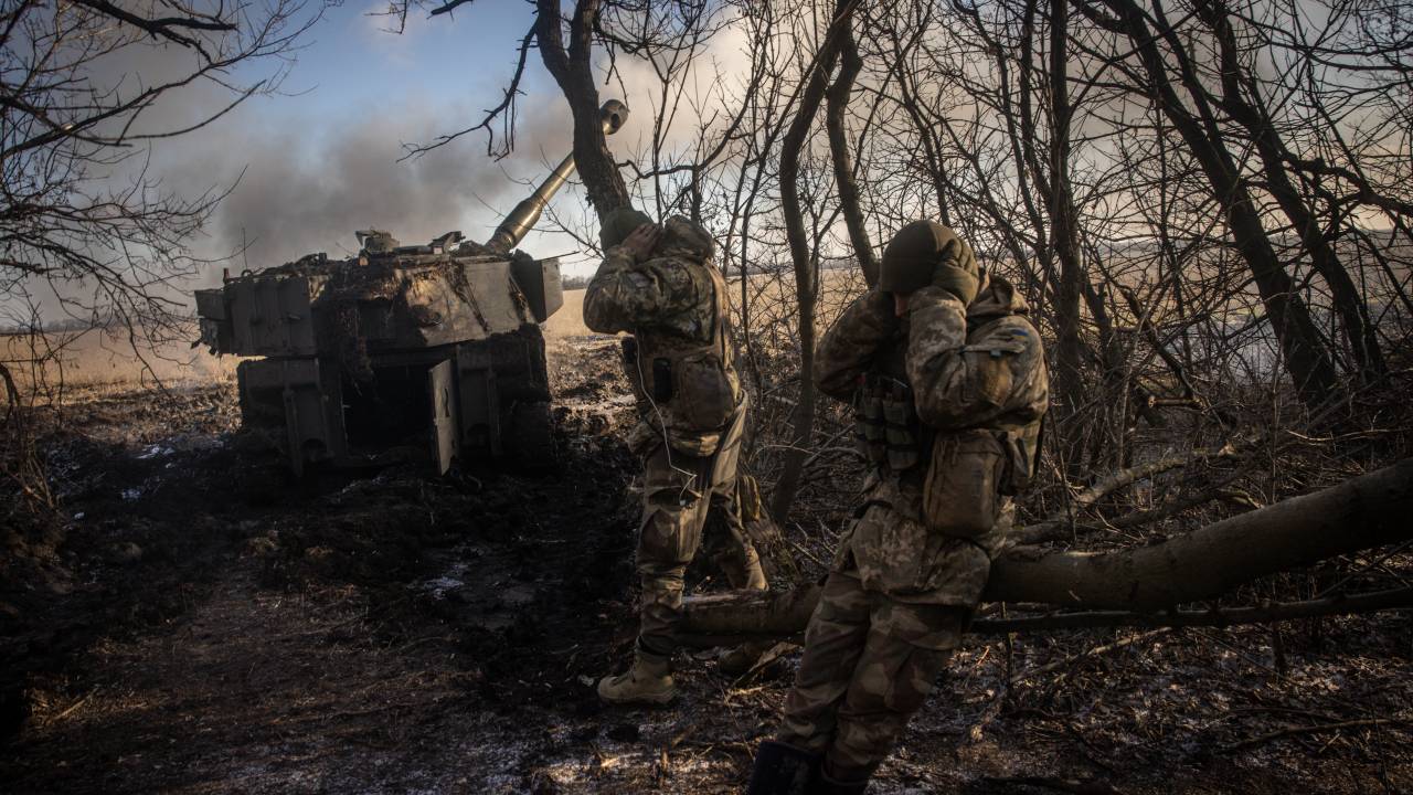 DONETSK, UKRAINE - DECEMBER 19: Members of a Ukrainian artillery unit cover their ears as an M109 self propelled artillery unit is fired at Russian mortar positions around Vuhledar from a frontline position on December 19, 2022 in Donetsk Region, Ukraine. A large swath of Donetsk region has been held by Russian-backed separatists since 2014. Russia has tried to expand its control here since the February 24 invasion. (Photo by Chris McGrath/Getty Images)