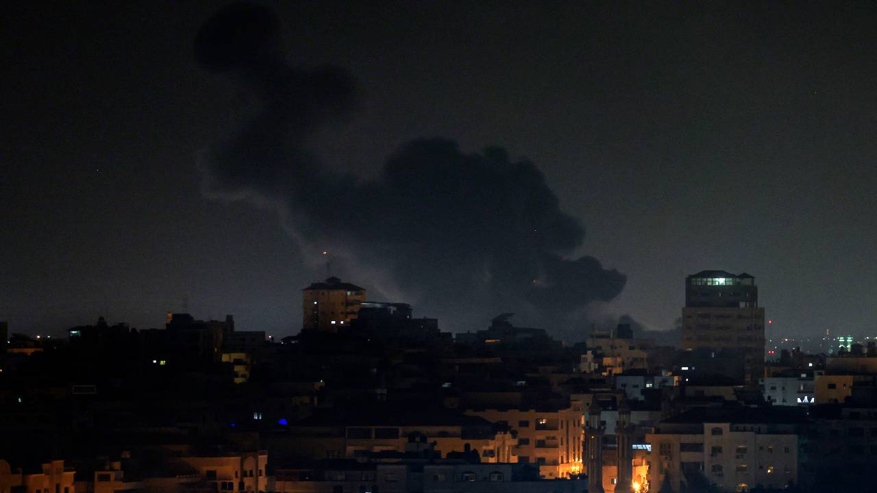 Smoke rises above buildings in Gaza City as Israel launched air strikes on the Palestinian enclave early on February 2, 2023. - Israel conducted air strikes on the central Gaza Strip hours after intercepting a rocket fired from the Palestinian territory, according to AFP journalists and witnesses on February 2, 2023. (Photo by MOHAMMED ABED / AFP)