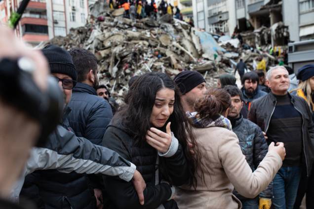 Uma mulher chora enquanto equipes de resgate procuram sobreviventes nos escombros de prédios desabados em Adana, na Síria - Uma mulher chora enquanto equipes de resgate procuram sobreviventes nos escombros de prédios desabados em Adana, na Síria -