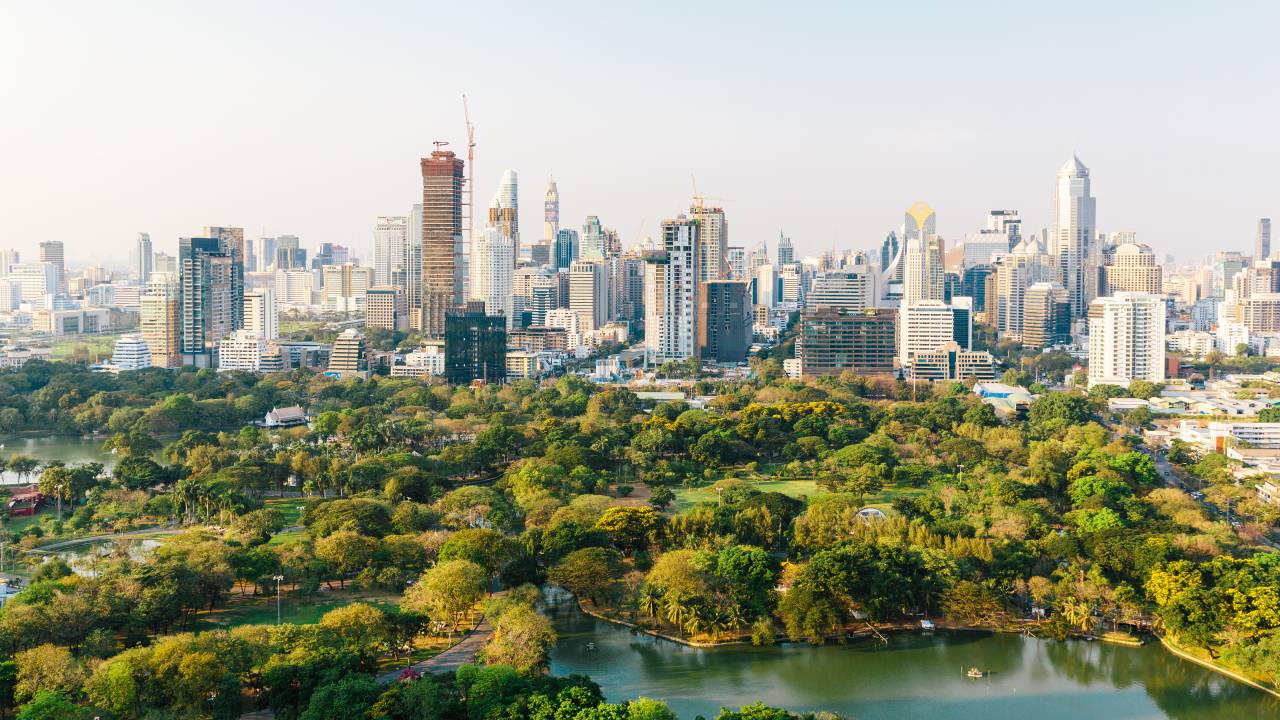 Bangkok cityscape with Lumpini park and modern skyscrapers, aerial view