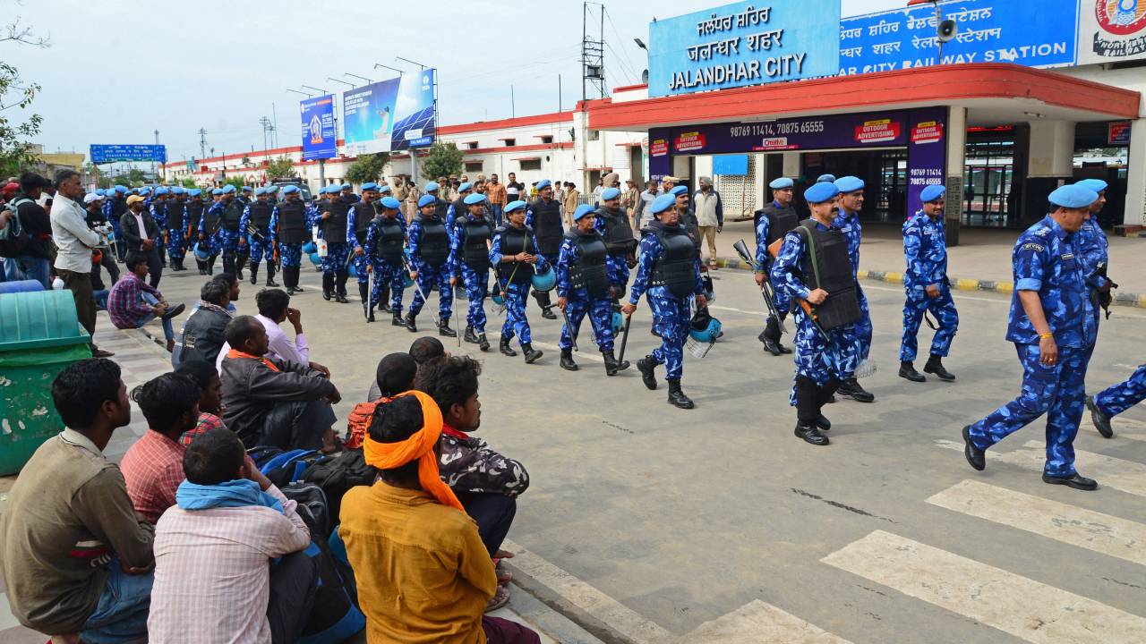 India's Rapid Action Force (RAF) personnel patrol in front of the railway station during a hunt for Sikh separatist, in Jalandhar on March 20, 2023. - Mobile internet in India's Punjab state remained suspended for a third day on March 20 as police hunted a radical Sikh preacher and protestors vandalised consulates abroad. (Photo by SHAMMI MEHRA / AFP)