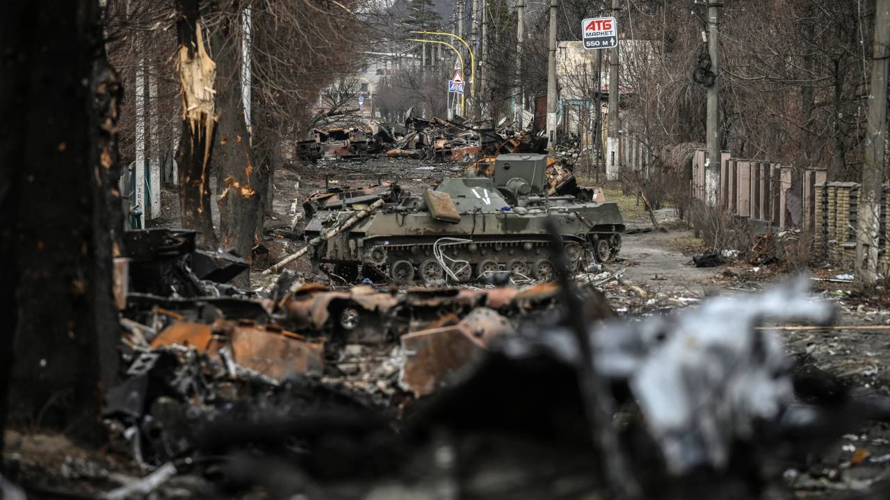 (FILES) In this file photo taken on March 4, 2022 Destroyed Russian armored vehicles line the street in the city of Bucha, west of Kyiv. - Russian forces pulled back from the commuter town northwest of the capital on March 31, 2022, just over one month after President Vladimir Putin ordered his troops to invade Ukraine. A year after its liberation by Ukrainian forces, Bucha and its people are still confronted by the atrocities blamed on Russian forces during their occupation of the city. President Volodymyr Zelensky said Friday that Ukraine would "never forgive" Moscow for its occupation of Bucha, one year after Russia withdrew from the town near Kyiv leaving corpses strewn throughout deserted streets. (Photo by ARIS MESSINIS / AFP)