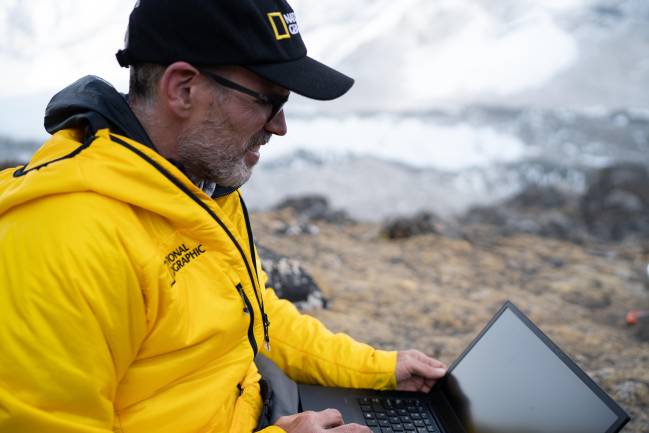 _DSC3772 Mount Everest, Nepal - 2019/04/28: Alex Tait works on a laptop while installing mapping hardware. Image taken near Everest Base Camp. The National Geographic and Rolex Perpetual Planet Everest Expedition was the most comprehensive single scientific expedition to the mountain in history. A diverse team of scientists, storytellers, and expert climbers and guides surveyed the mountain's geography, geology and biodiversity; installed a network of weather stations, including the world's highest; and collected ice and lake cores, all in order to better understand the impacts of climate change on the world's tallest mountain.