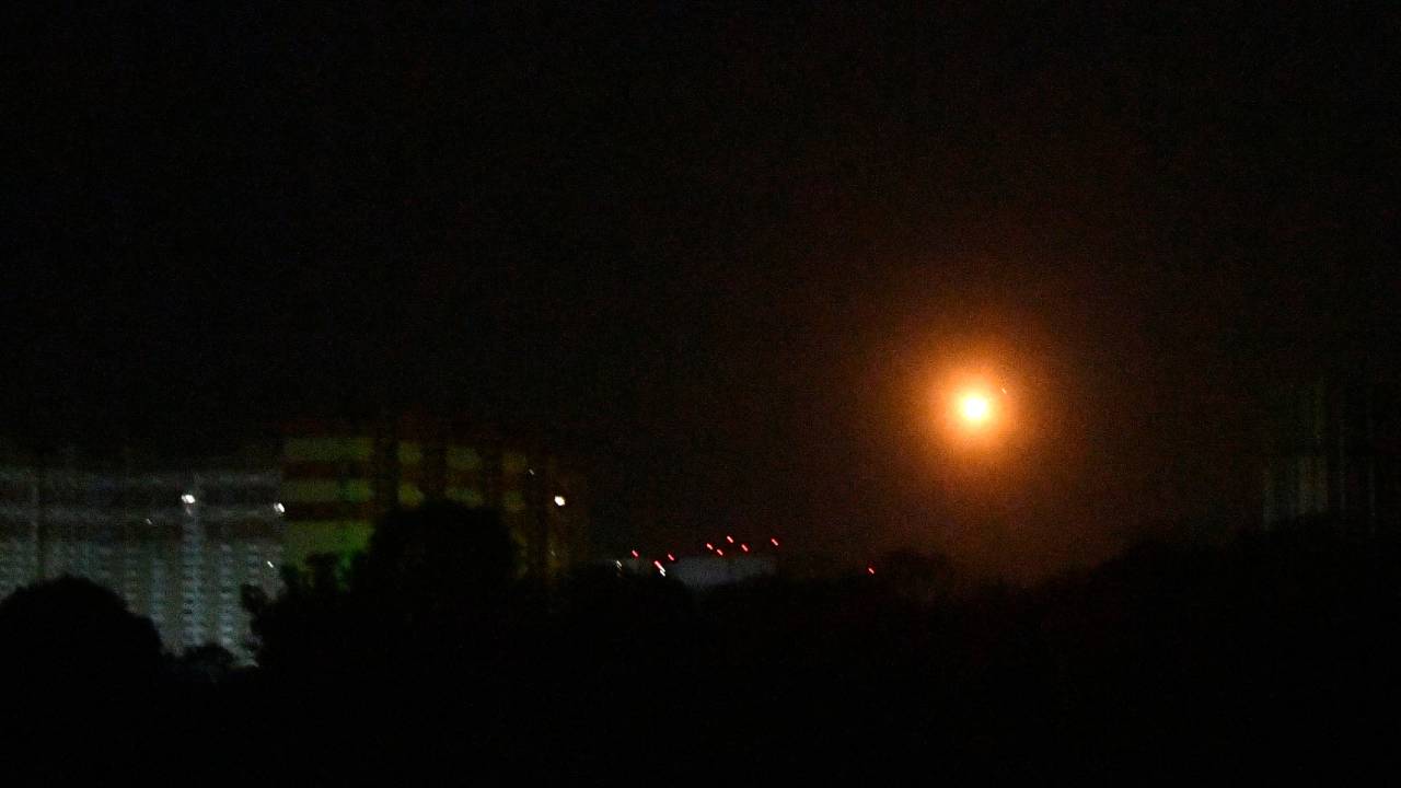 The picture shows an explosion over Kyiv during a Russian missile strike early on May 16, 2023. Ukraine said Tuesday it had downed six advanced Russian hypersonic missiles during an overnight barrage of missiles and drones, in a new show of its bolstered air defence systems. (Photo by Sergei SUPINSKY / AFP)