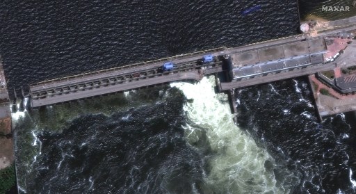 This handout satellite image courtesy of Maxar technologies shows a closer view of a destroyed roadway and section of the Nova Khakovka dam in south Ukraine, on June 5, 2023. Ukrainian President Volodymyr Zelensky will urgently convene his Security Council on June 6, 2023 after an explosion at the Kakhovka hydroelectric dam in the south of the country, a top adviser said. (Photo by Satellite image ©2023 Maxar Technologies / AFP) / RESTRICTED TO EDITORIAL USE - MANDATORY CREDIT "AFP PHOTO / Satellite image ©2023 Maxar Technologies" - NO MARKETING NO ADVERTISING CAMPAIGNS - DISTRIBUTED AS A SERVICE TO CLIENTS