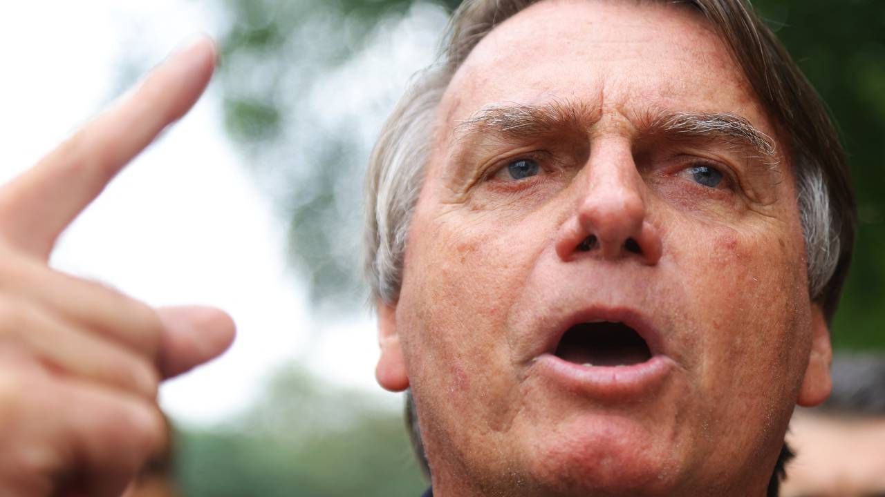 Brazilian former President Jair Bolsonaro speaks to the press after an event held by the Liberal Party at the Auditorio Dante Barone in Porto Alegre, Brazil on June 23, 2023. (Photo by SILVIO AVILA / AFP)