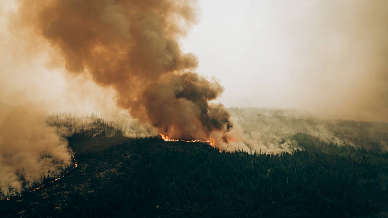 This June 4, 2023, aerial image released by the Societe De Protection Des Forets (SOPFEU) on June 29, 2023, shows a fire burning in the Baie Pénicouane area of Quebec, Canada. Smoke from Canada's worst-ever wildfires was severely impacting air quality June 28, 2023, across Ontario and at least 15 US states, with monitors warning that over one hundred million people face potentially unhealthy conditions. The wildfires, the largest ever recorded in Canada, have raged for two months. (Photo by Audrey Marcoux / Societe De Protection Des Forets / AFP) / RESTRICTED TO EDITORIAL USE - MANDATORY CREDIT "AFP PHOTO / Audrey Marcoux/SOPFEU" - NO MARKETING NO ADVERTISING CAMPAIGNS - DISTRIBUTED AS A SERVICE TO CLIENTS