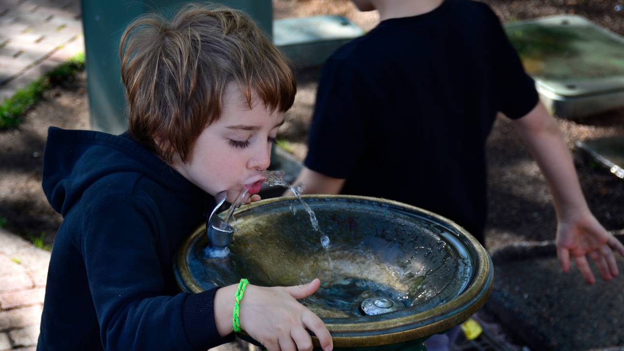 SANTA FE, NM - JULY 29, 2017: A small boy drinks from a public drinking fountain in the historic Plaza in Santa Fe, New Mexico. (Photo by Robert Alexander/Getty Images)
