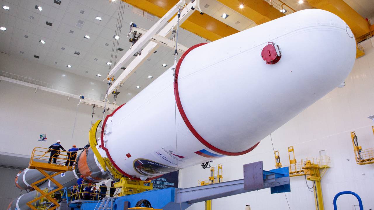 This handout photograph taken and released by the Russian Space Agency Roscosmos on August 7, 2023, shows technicians finishing to assemble a Soyuz 2.1b rocket carrying the Luna-25 lander ahead of its launch scheduled for August 11, 2023, at the Vostochny cosmodrome, some 180 km north of Blagoveschensk, in the Amur region. Russia said on August 7, 2023 it plans to launch a lunar lander later this week after multiple delays, hoping to return to the Moon for the first time in nearly fifty years. (Photo by Handout / Russian Space Agency Roscosmos / AFP) / RESTRICTED TO EDITORIAL USE - MANDATORY CREDIT "AFP PHOTO / Russian Space Agency Roscosmos / handout" - NO MARKETING NO ADVERTISING CAMPAIGNS - DISTRIBUTED AS A SERVICE TO CLIENTS
