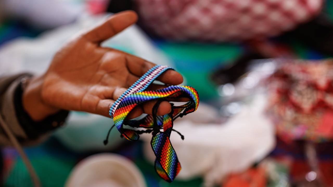 KAMPALA, UGANDA - APRIL 24: A woman identifying as a lesbian makes jewellery to sell whilst at a shelter for lesbian, bisexual, and queer women on April 24, 2023 in Kampala, Uganda. The shelter aims to not only house sexual minorities, but to give the women skills training, counselling, and access to healthcare. Uganda's policymakers have yet to pass the pending anti-gay law that has caused backlash from the international community, with the hardline bill imposing capital and life-imprisonment sentences for gay sex.