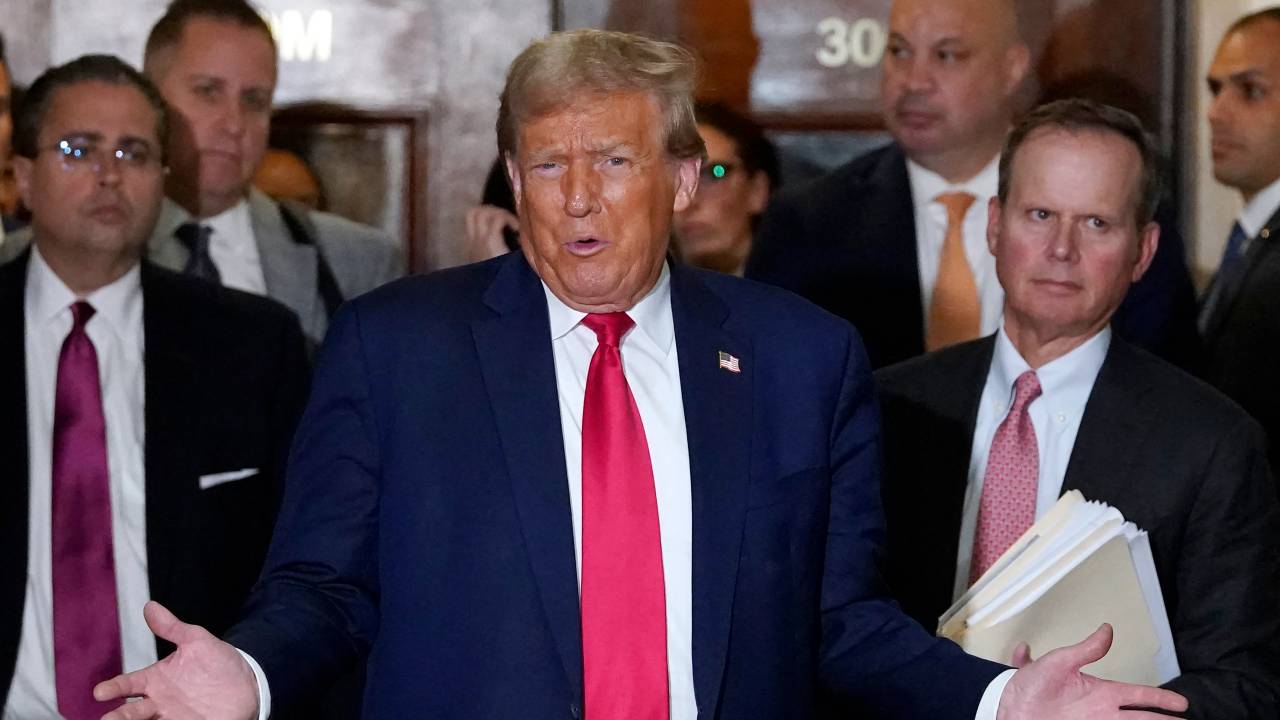 Former President Donald Trump speaks to the press during a break from court in his $250 million civil fraud trial against him and his company October 17, 2023. Trump attends the trial a day after a federal judge, in a separate criminal case, imposed a partial gag order on Trump, on October 16. (Photo by TIMOTHY A. CLARY / AFP)